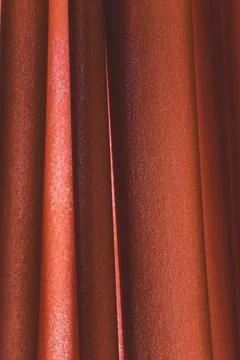 Full frame of red folded silk velvet fabric as background, vertical lines Stock Photos