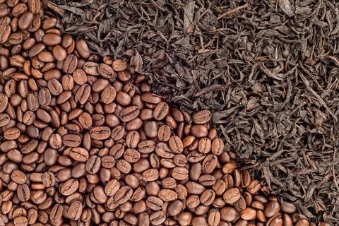 Full frame of roasted coffee beans and tea leaves arranged diagonally. Stock Photos