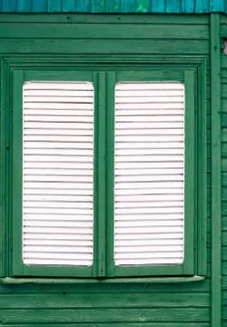 Full frame shot of shutter of old white timber window on green wooden buildin Stock Photos