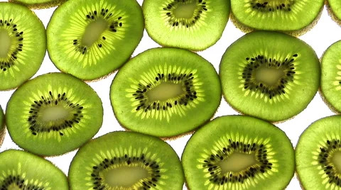 Full frame slices of kiwis rotate through frame Stock Footage 46585436