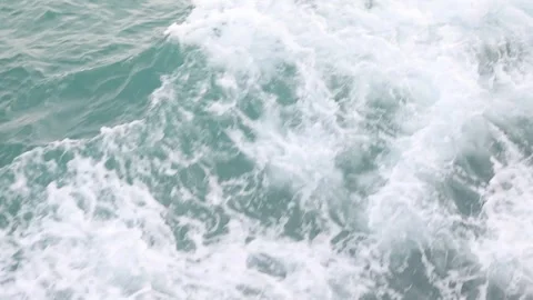 Full frame slow motion video of rough ocean surface with swirling whitewash Stock Footage 343820736