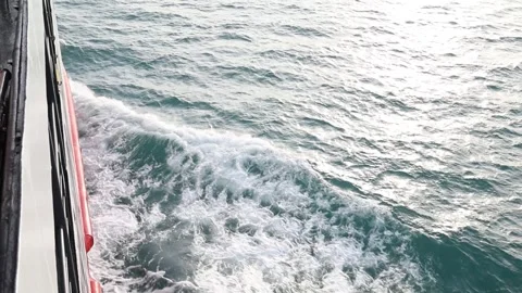 Full frame slow motion video of rough ocean surface with swirling whitewash Stock Footage 343820756