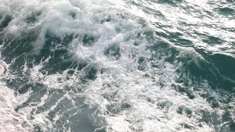Full frame slow motion video of rough ocean surface with swirling whitewash Stock Footage 343825468