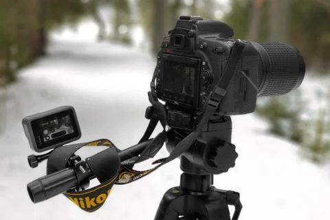 Full-frame SLR camera on a tripod, in the process of shooting Stock Photos