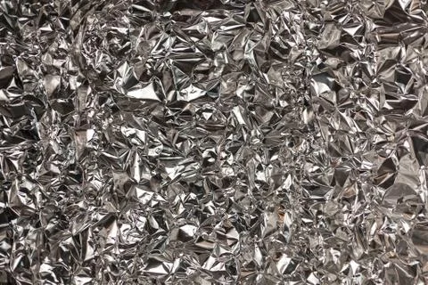 Full frame take of a sheeT of crumpled silver aluminum foil Foto stock