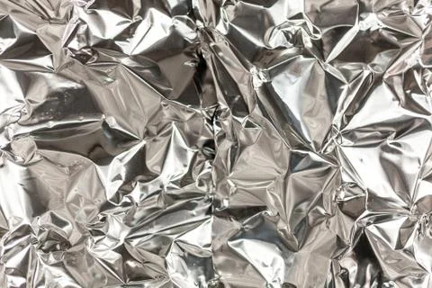 Full frame take of a sheeT of crumpled silver aluminum foil Stock Photos
