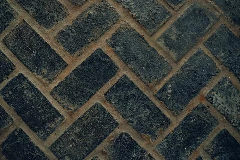 Full frame texture background of herringbone pattern concrete paving bricks. Stock Photos