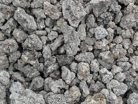 Full frame texture background of rough gray volcanic rock and porous lava stones Stockfoto's