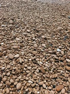 Full frame texture of smooth rounded pebbles on Cap d'Ail beach Stock Photos