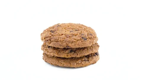 Full frame of a three soft and chewy chocolate chip oatmeal cookies rotating Stock Footage 94898604
