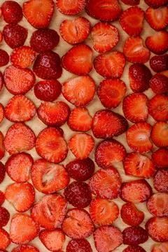Full frame vertical background of cut strawberries. Stock Photos