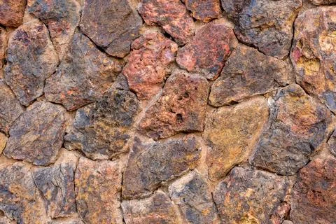 Full frame view of a rustic, textured wall composed of colorful, irregularl.. Stock Photos