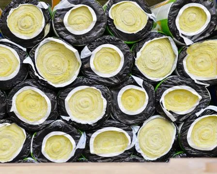 Full frame view of  yellow compressed and rolled mats made of mineral wool gl Stock Photos