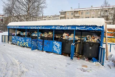 Full garbage cans are on the garbage site in winter Stock Photos