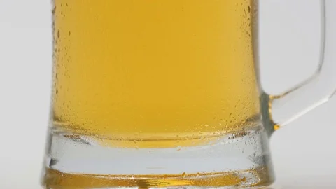 Full glass of cold light beer on a white background Video stock 129714280