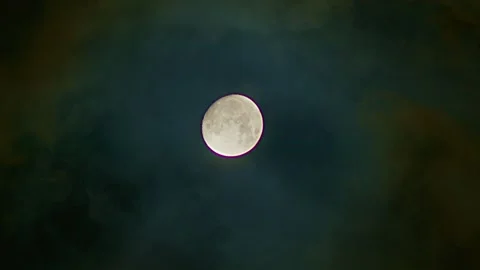 Full glowing moon with clouds being blown by winds at nights. An ominous full Stock Footage 254239889
