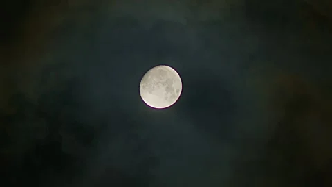Full glowing moon with clouds being blown by winds at nights. An ominous full Stock Footage 254403822