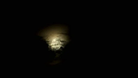Full glowing yellow moon with clouds carried by the winds during a storm at Stock Footage 163029110