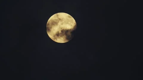 Full golden moon, clouds slowly drift across the moon surface Stock Footage 345131712