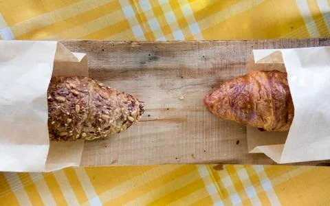 Full grain vs regular croissant croissant on the wooden plank Stock Photos