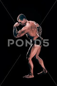 In full growth. handsome bodybuilder guy showing his biceps. Stock Photos
