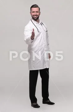 In full growth. the medical doctor holding out his hand for a handshake Stock Photos