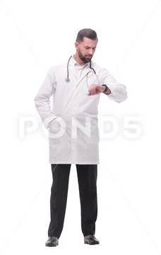 In full growth. medical doctor looking at his wrist watch Stock Photos