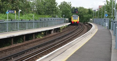 Full HD 4K video clip of a new train leaving Hampton Wick station in south Stock Footage 247516998