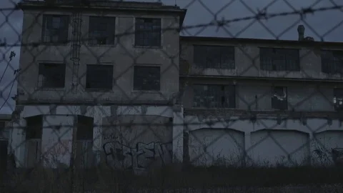Full HD EXT DAY static old abandoned building with graffiti behind a fence Stock Footage 73110239
