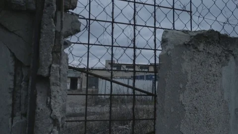 Full HD EXT DUSK pan old abandoned building with a damaged wall and a fence Stock Footage 73110240