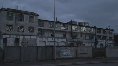 Full HD EXT DUSK static old abandoned building behind a fence Stock Footage 73110086