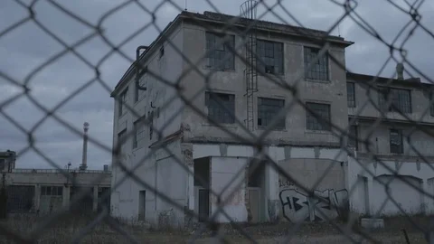 Full HD EXT DUSK static old abandoned factory behind a fence Stock Footage 73110125