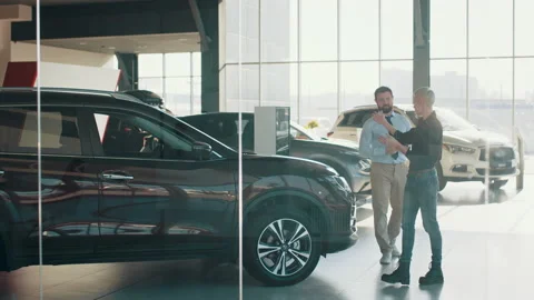 Full height of man, competent car dealer using digital tablet for work with Stock Footage 180375488