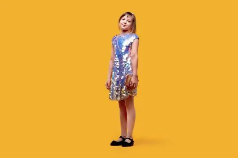 In full height smiling dancing cute girl looks into the camera. Holiday dress Stock Photos