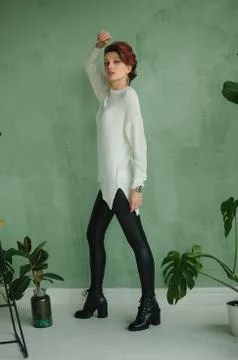 Full height studio portrait of tall young fashion model wearing white sweater Stock Photos