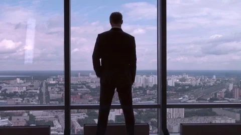 Full length back view of successful businessman in suit standing in office with Stock Footage 78140439