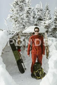 Full length of confident hiker wearing ski-wear while standing on snowy field Stock Photos
