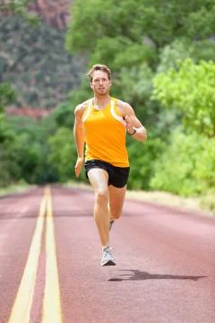 Full Length Of Determined Man Running On Road Stock Photos