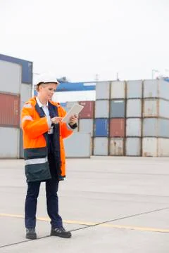 Full-length of female engineer using tablet computer in shipping yard Stock Photos