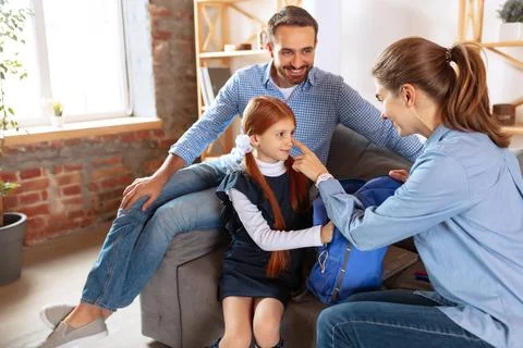 Full-length image of happy smiling family, father and mother, preparing little Stock Photos