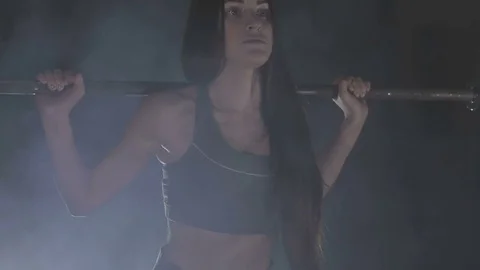 Full length image of a young woman testing her strength by holding a barbell Stock Footage 73107585