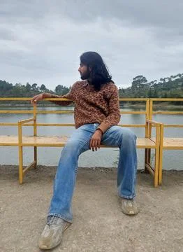 Full length of a long haired and bearded young man looking sideways  Stock Photos