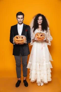 Full length photo of beautiful zombie couple bridegroom and bride wearing wed Stock Photos