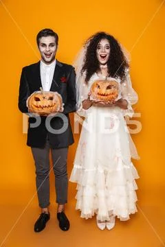 Full length photo of terrifying zombie couple bridegroom and bride wearing we Stock Photos
