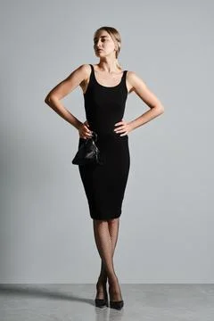 Full length portrait of beautiful model posing with triangular hand bag and h Stock-Fotos