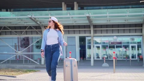Full length portrait of cheerful young woman in summer cap and sunglasses walkin Stock Footage 140115756