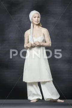 Full Length Portrait Of Confident Woman Standing Against Gray Background
