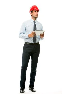 Full length portrait of a construction supervisor with digital tablet looking Stock Photos