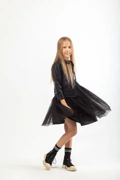 A full-length portrait of dancing young girl with long brown hair dressed in  Fotos de archivo