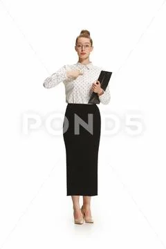 Full length portrait of a female teacher holding a folder isolated against white Stock Photos